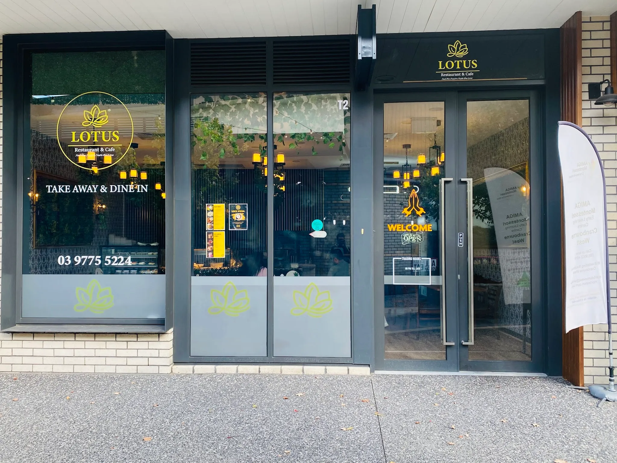 Lotus Restaurant & Cafe storefront with gold lotus signage and glass shopfront
