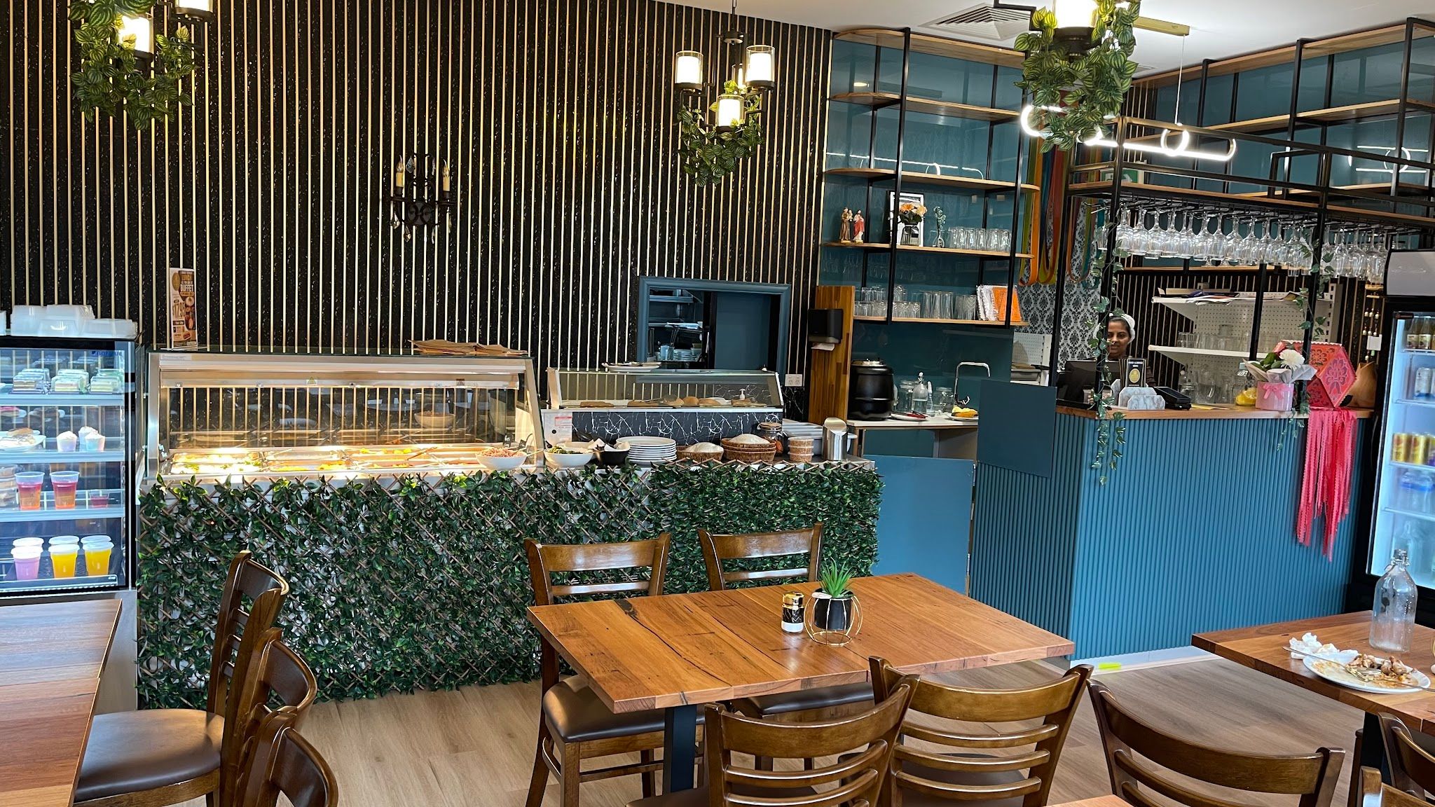 Lotus cafe dining room with timber tables, food display cabinets and staff
