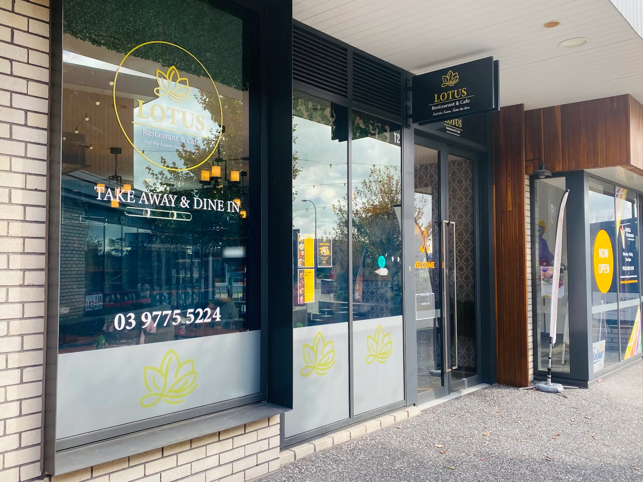 Lotus Restaurant & Cafe shopfront exterior with gold circular lotus sign